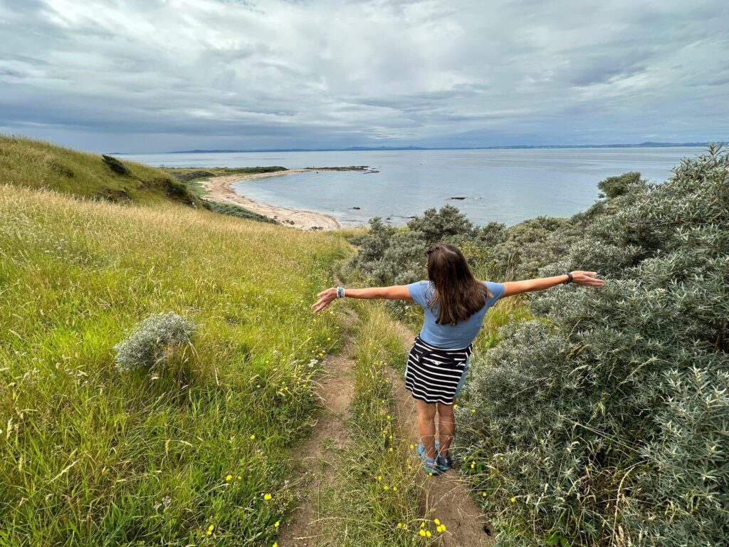 happy person looking down to beach